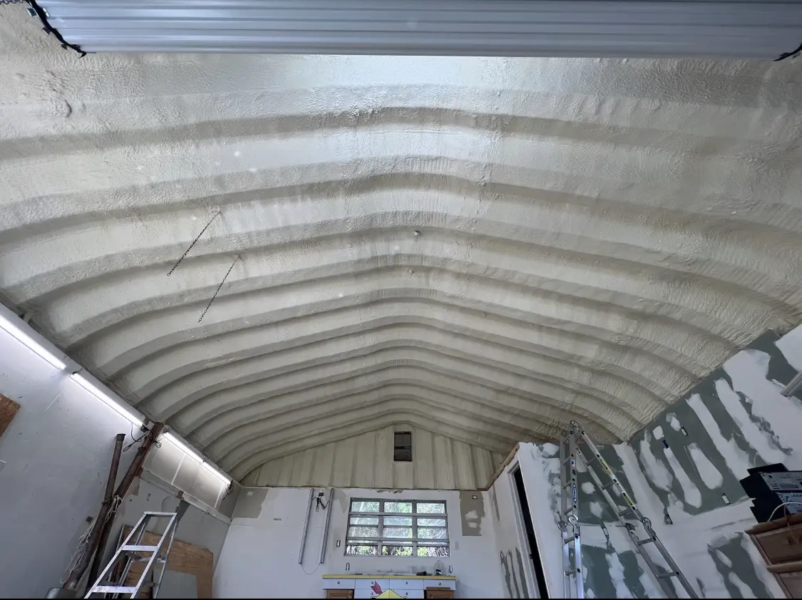 Spray polyurethane foam applied to the underside of a metal roof deck in Wright